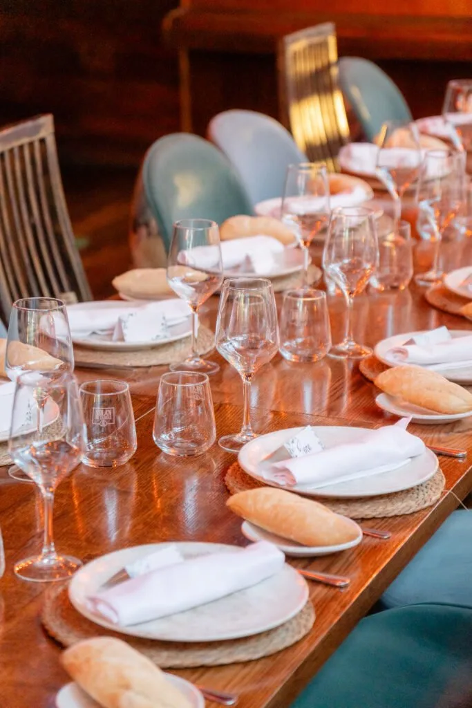Long table set with glasses and plates