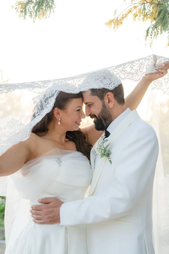 Couple face to face under a veil