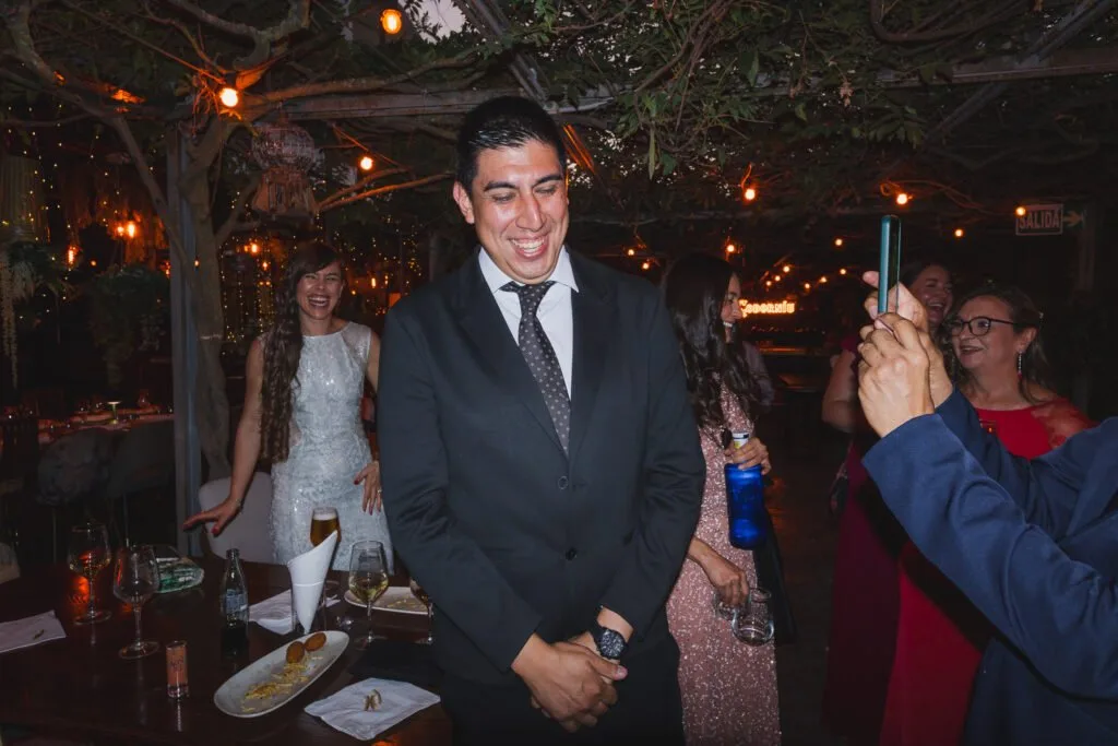 Guest in a suit at a night-time celebration under string lights