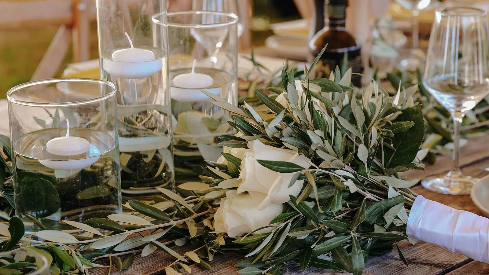 Detail of a wedding table with olive branches and candles