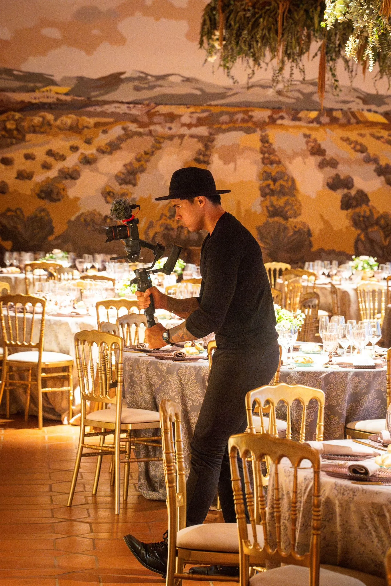 The videographer setting up a banquet hall with his gimbal
