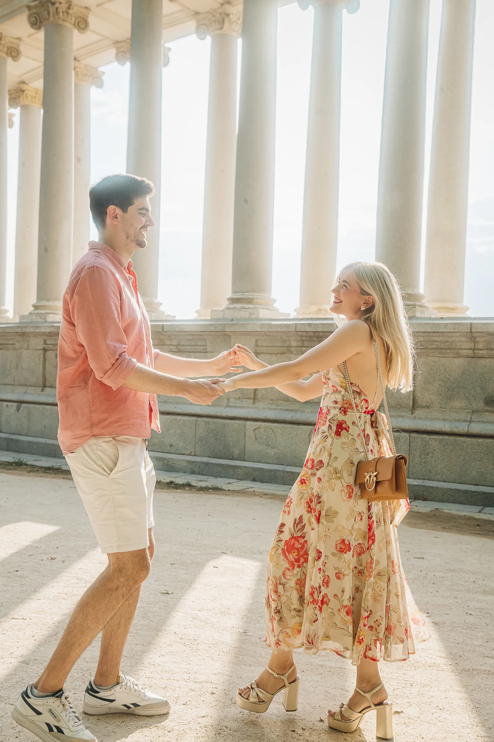 A couple dancing among stone columns in afternoon light