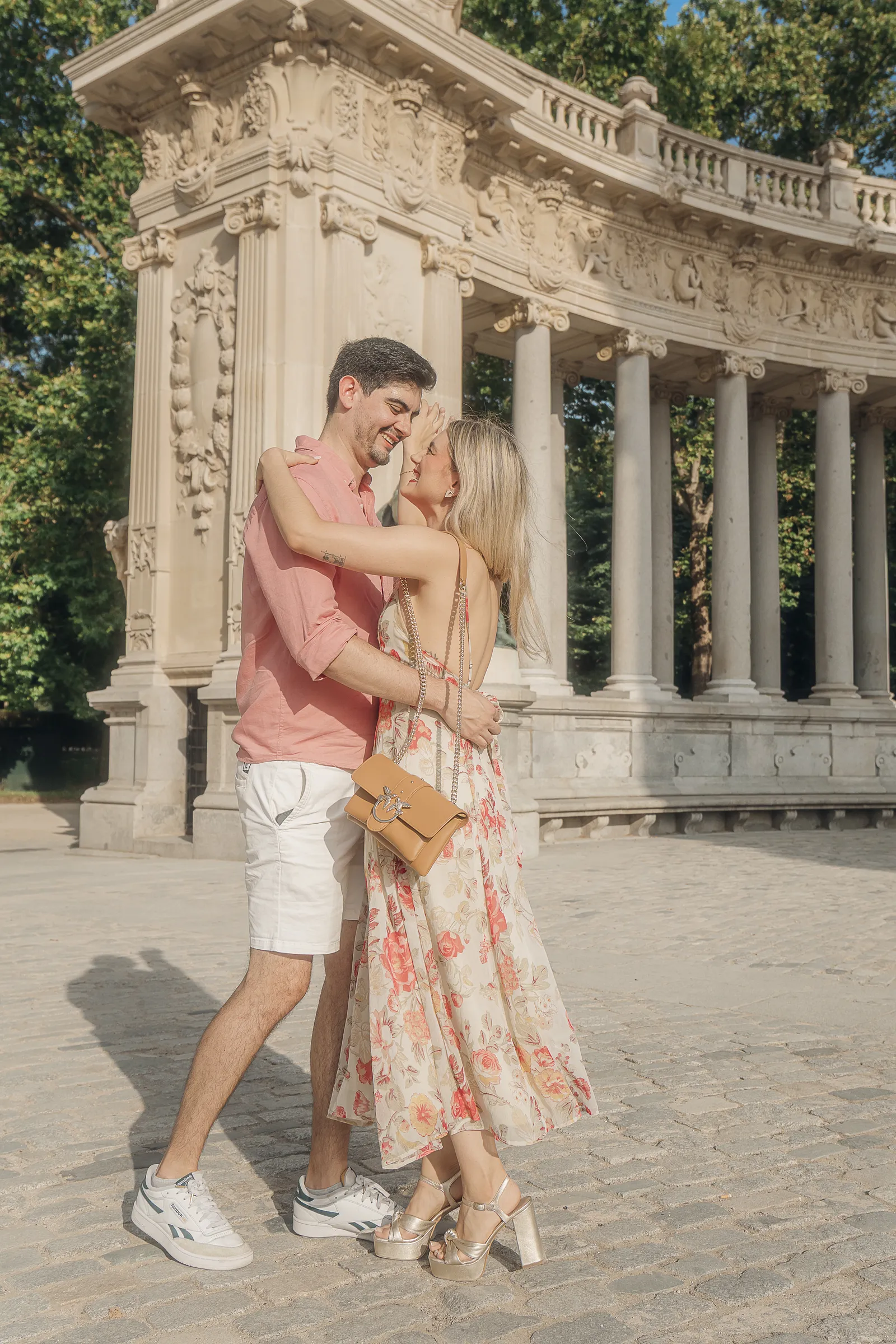 Couple embracing under a stone colonnade