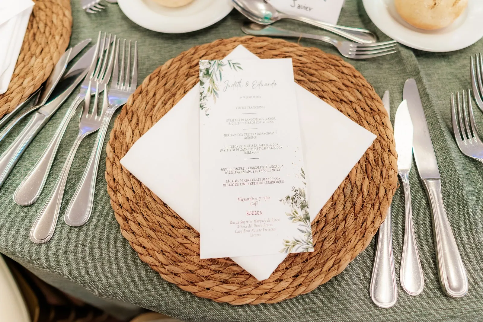 Place card on a wicker charger, with the cutlery