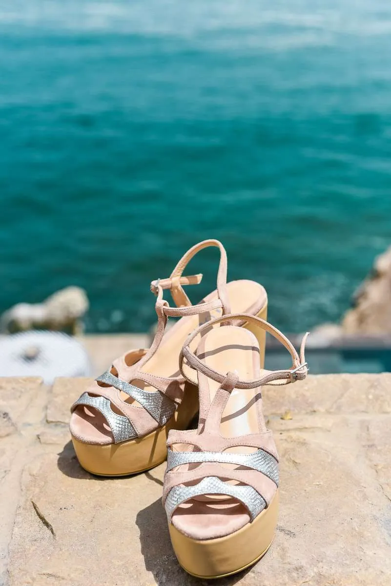 Bridal shoes on a stone terrace facing the sea