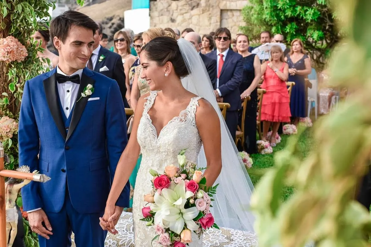 Couple holding hands in front of the guests