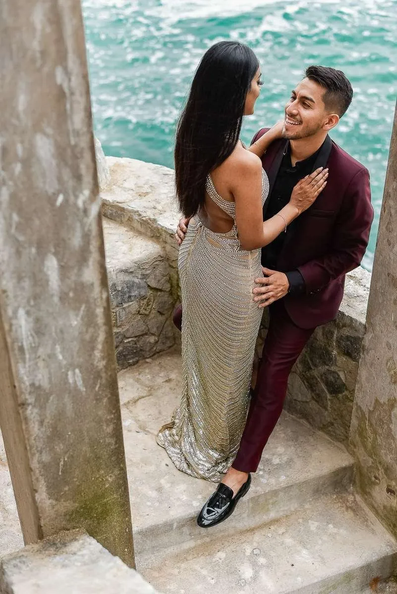 Stone pillars and steps above the water, with a couple embracing