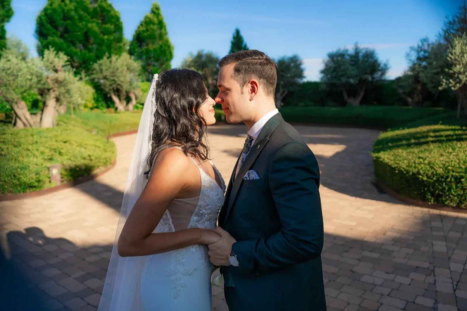 A couple among hedges in a garden, in golden afternoon light